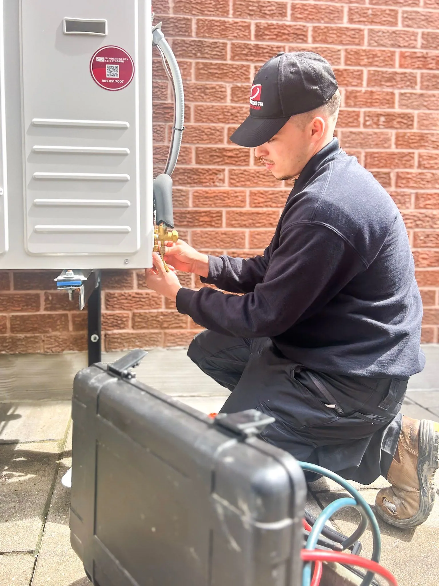Technician working on a heat pump air conditioning unit.