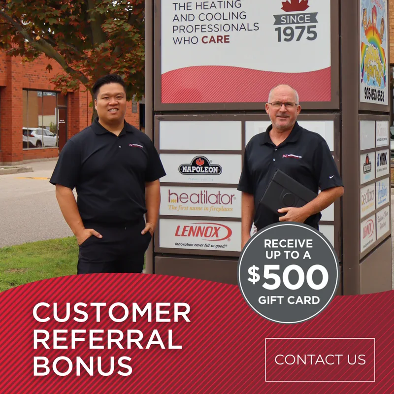 Two HVAC technicians next to a promotional sign.