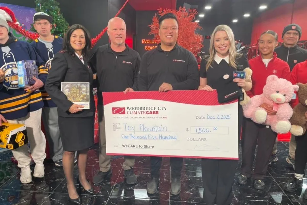 Group presenting a donation check during a holiday event.