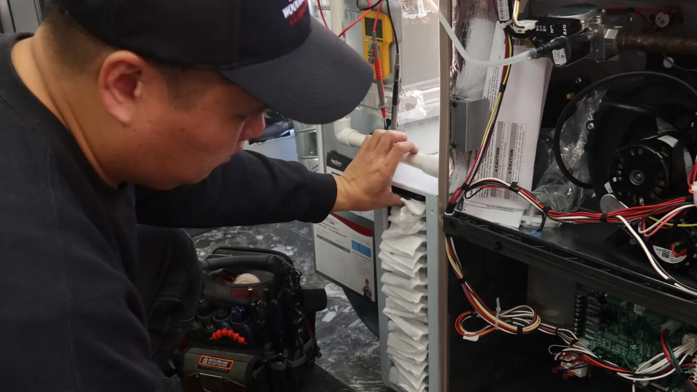 A technician servicing an HVAC unit.