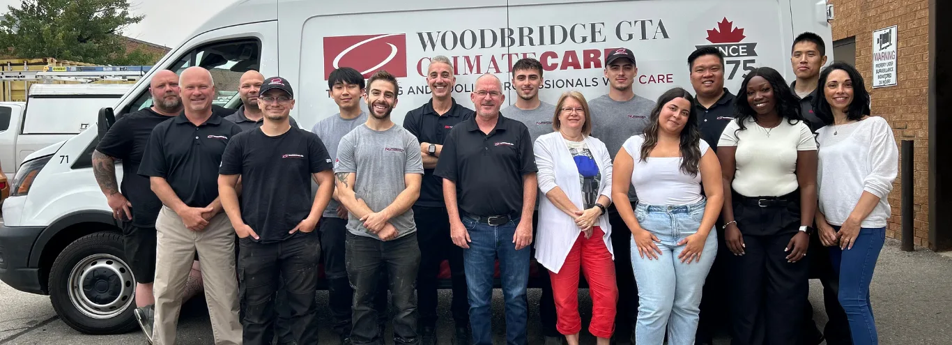 HVAC team posing in front of service van.