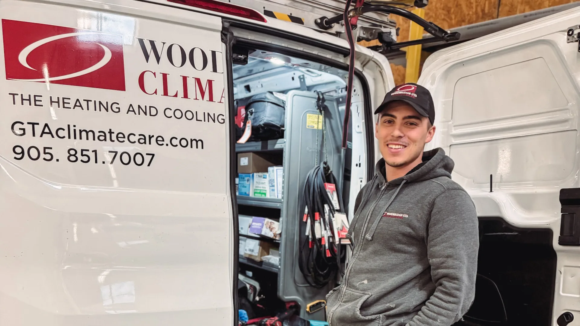 HVAC technician next to a service van.
