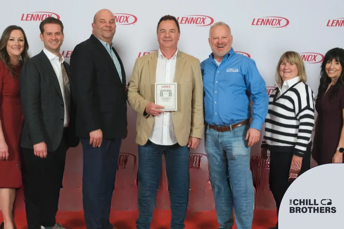 A group photo of The Chill Brothers with an award plaque