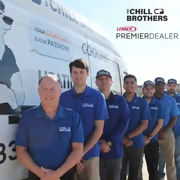 A team of HVAC technicians in front of a branded service van.