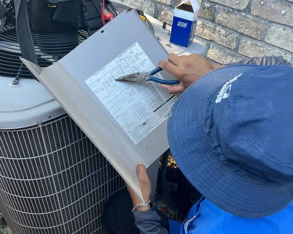 A technician reviewing HVAC service documentation outdoors.