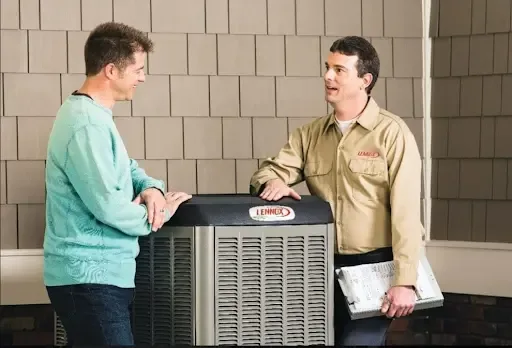 Technicians discussing an AC unit at a home.