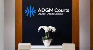 Reception area with ADGM Courts logo and white orchids