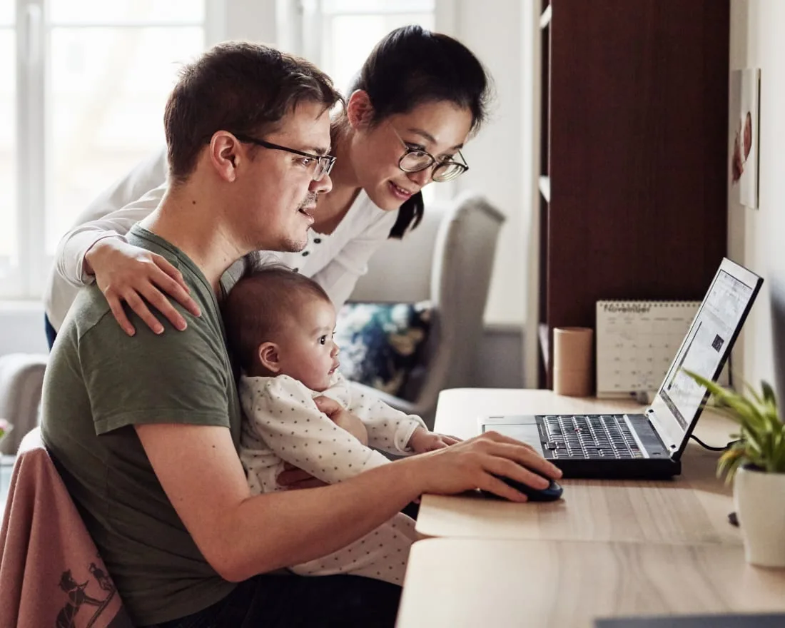 A family using a laptop at home.