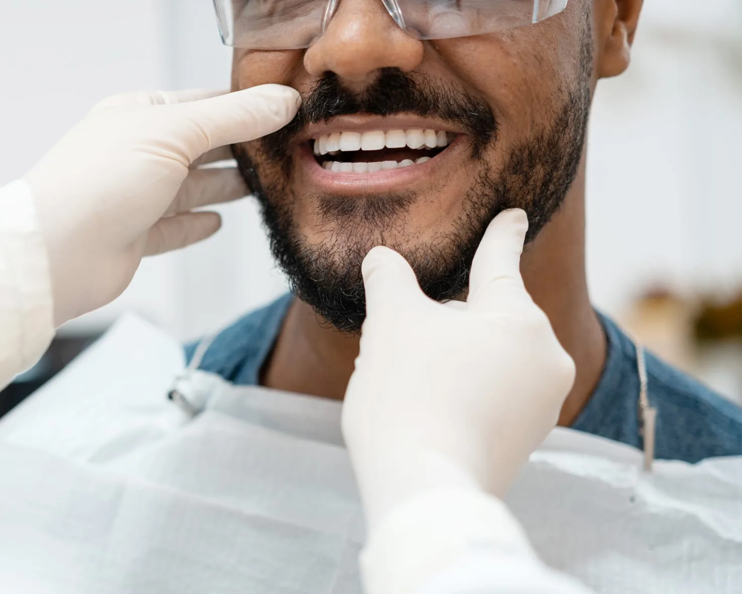 A man smiling during a dental examination.