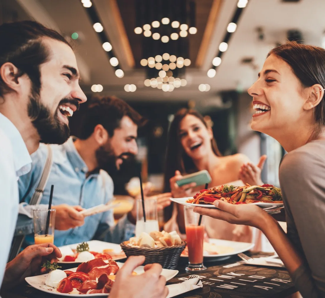 A group of friends enjoying a meal in a restaurant.