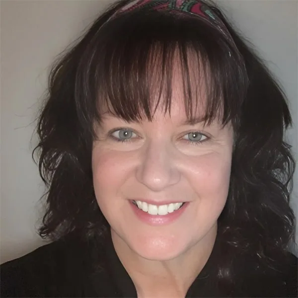 Smiling woman with curly hair and headband