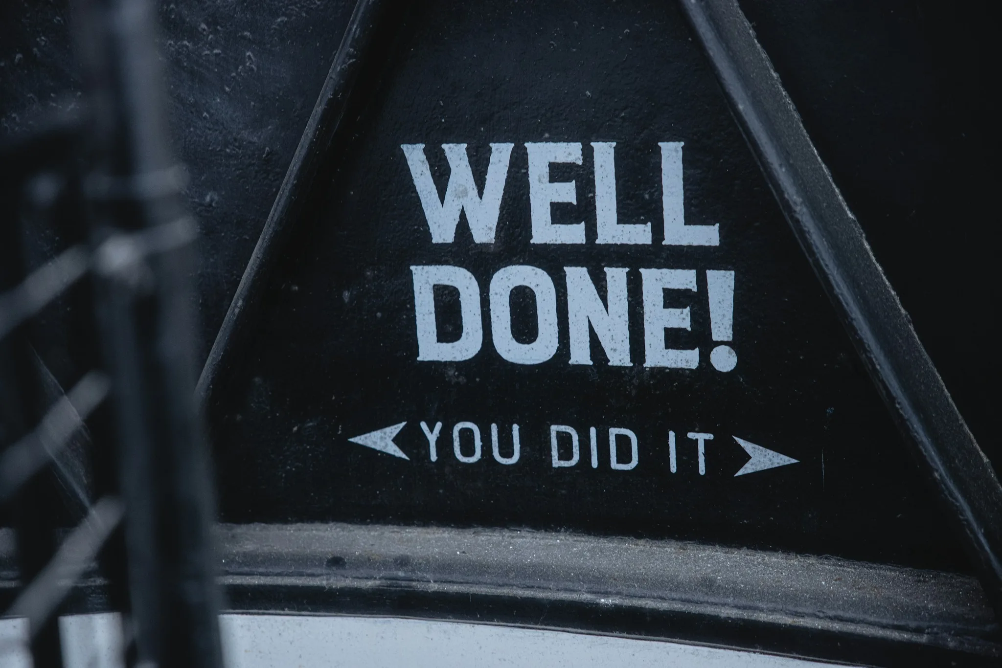 Motivational message on a black surface saying 'WELL DONE!'
