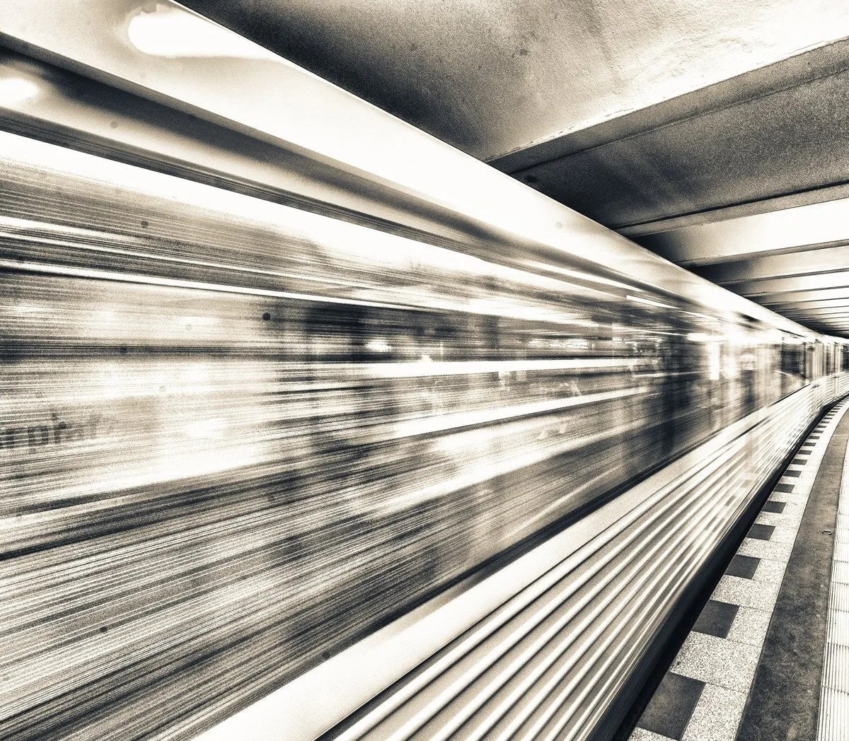 Motion blur of a subway train in a station.