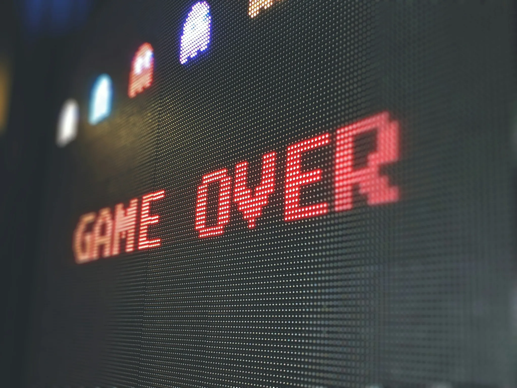 Pixelated game over screen with red text.