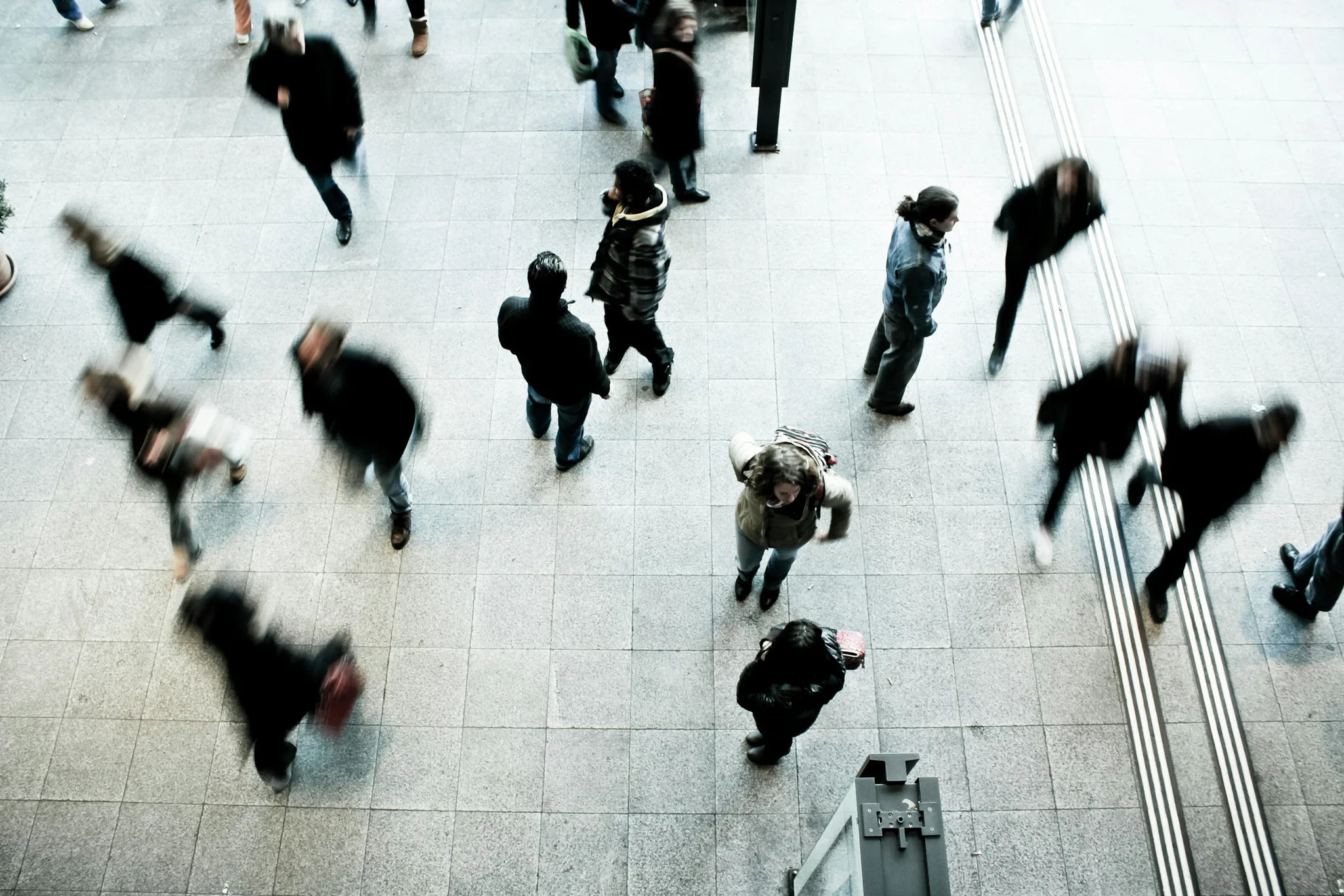 A busy crowd walking in an urban setting.