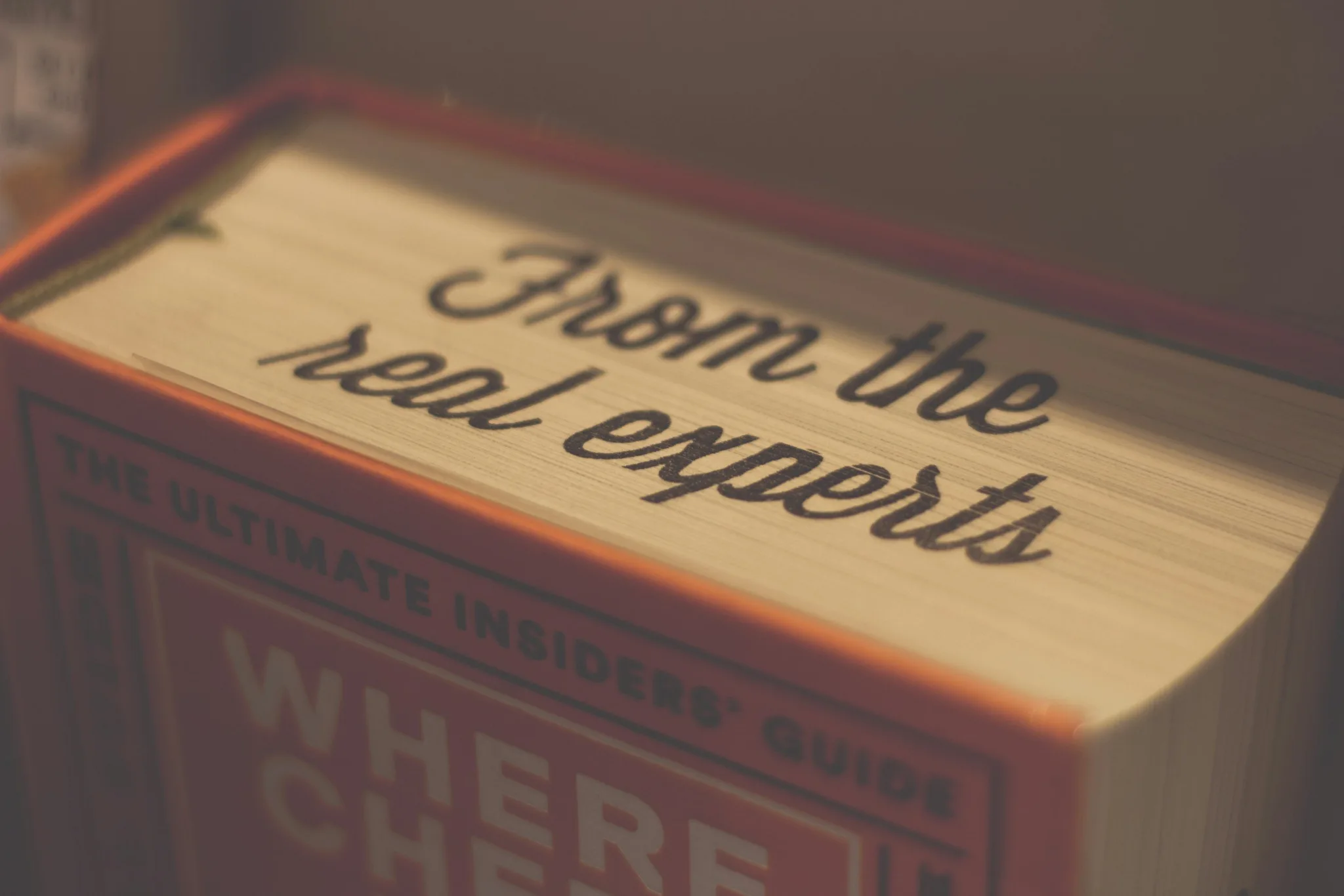 Close-up of a book spine with text 'From the real experts.'