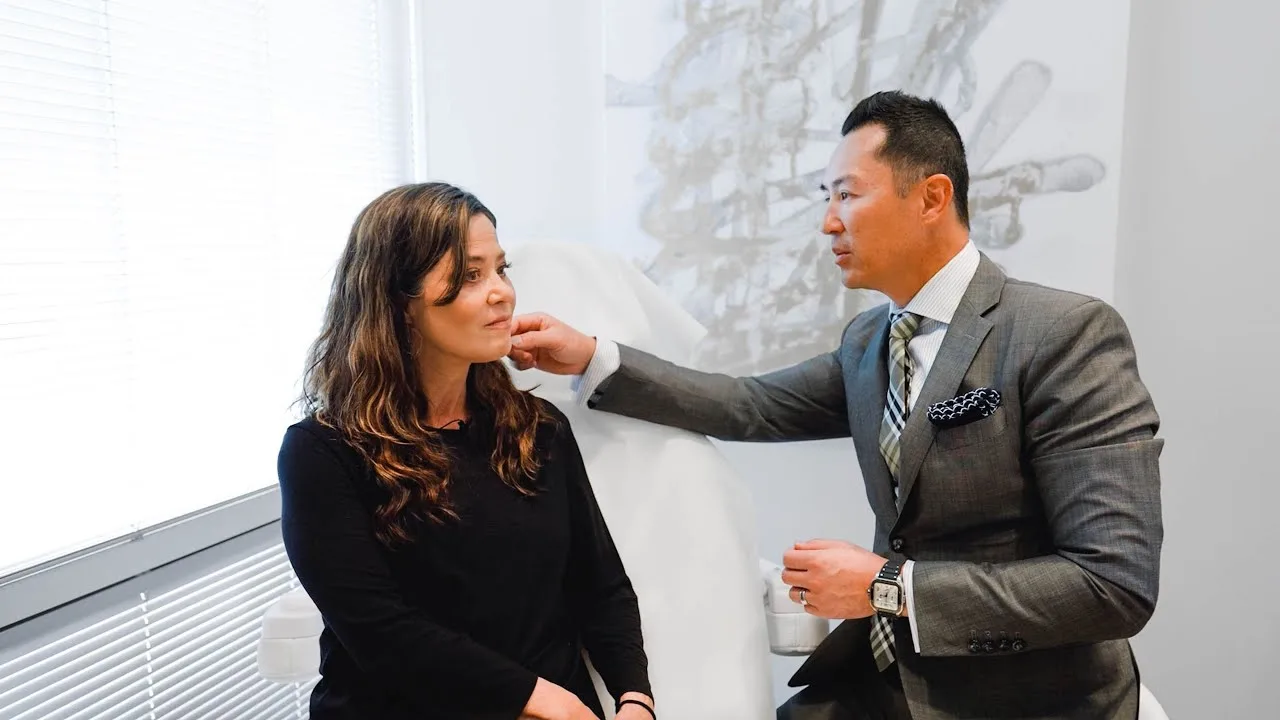 A doctor consulting with a patient in a cosmetic clinic.