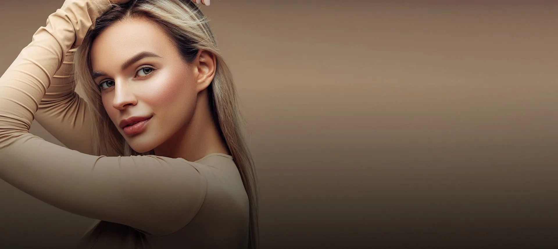 A young woman posing with a neutral background.