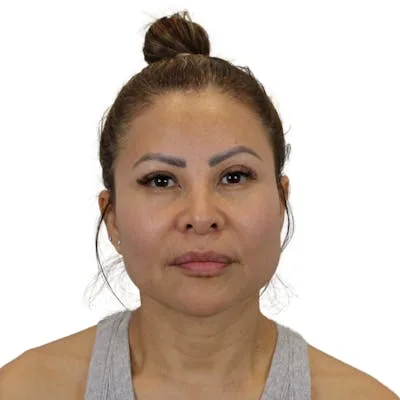 A woman with a neutral expression facing the camera.