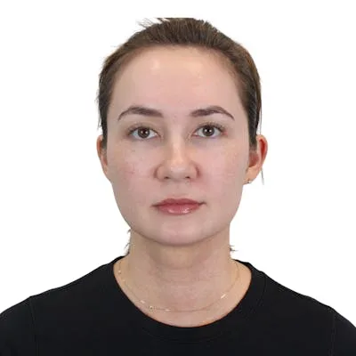 A woman with a neutral expression against a white background.