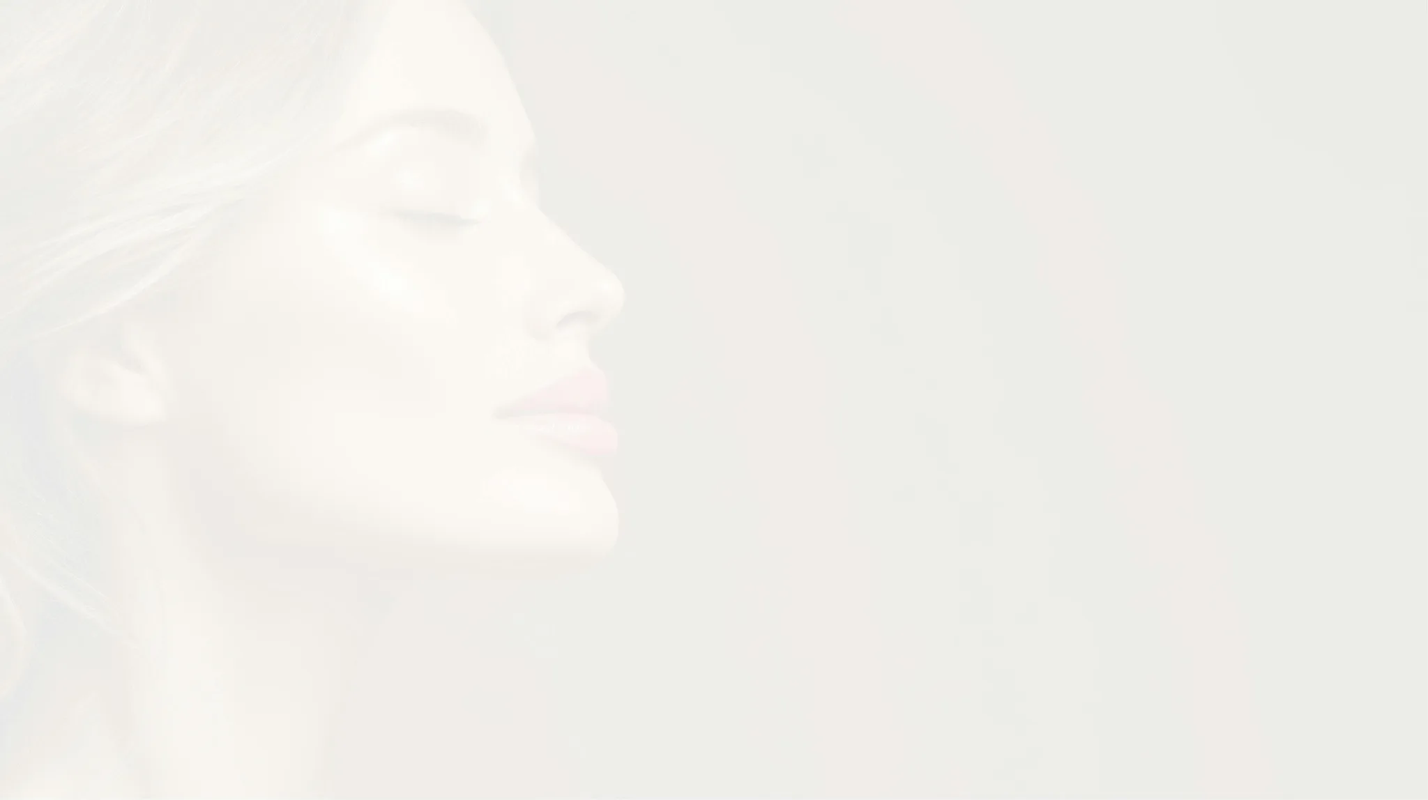 Profile view of a woman with full lips and relaxed expression.
