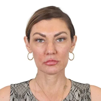 A woman with defined facial features and hoop earrings.