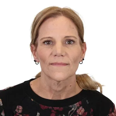 A woman posing against a white background.