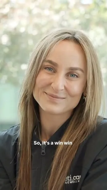 Smiling woman in a medspa uniform