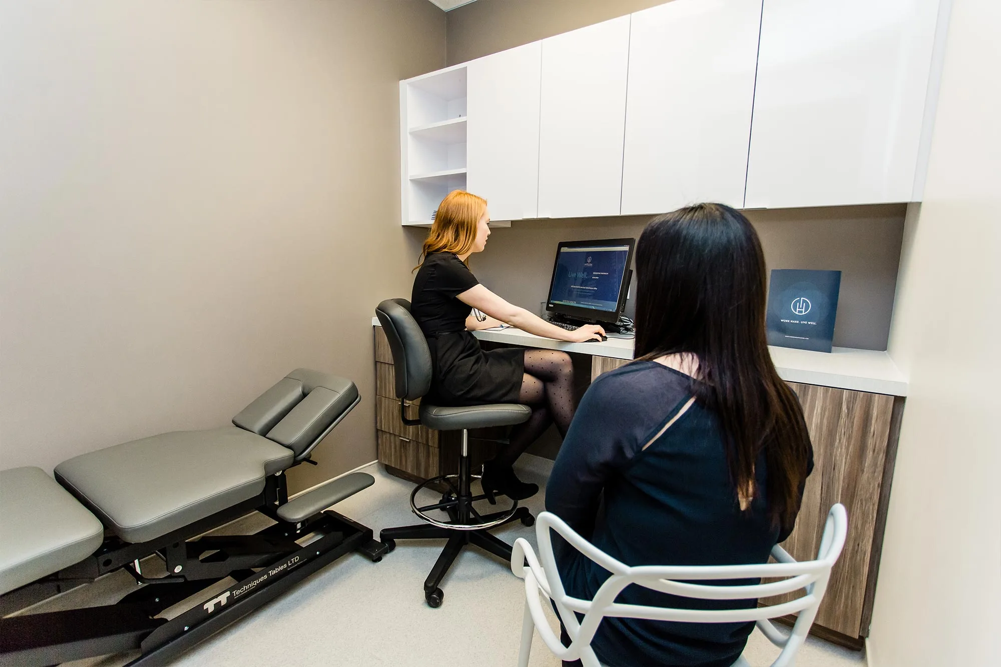 A medical consultation room with two people.
