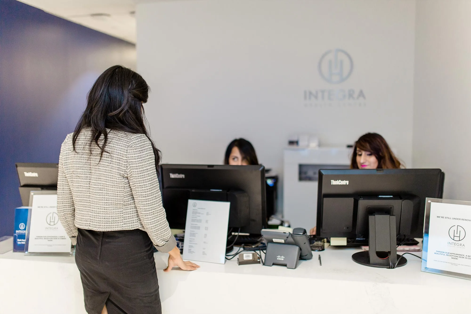 A reception area at Integra Health with staff behind the desk.