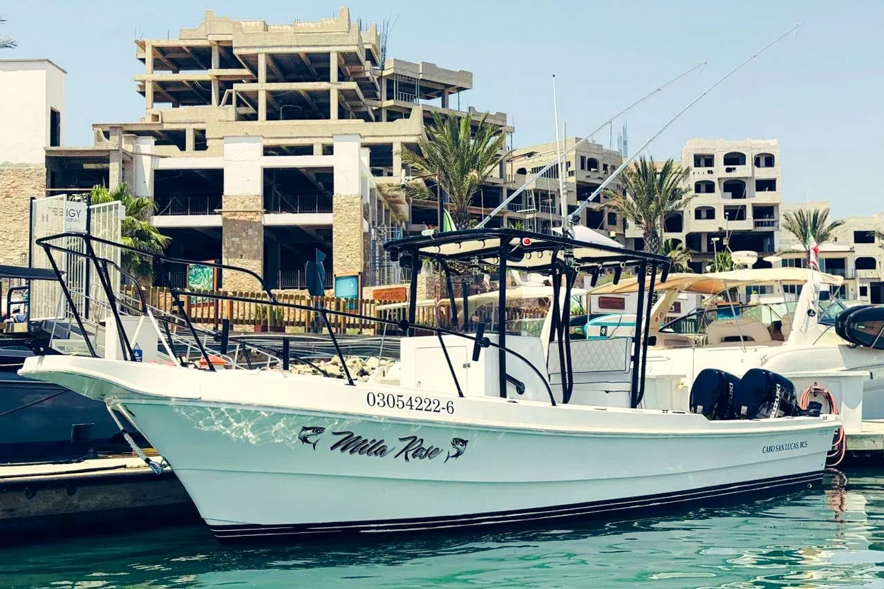 A fishing boat named 'Mila Rose' docked at a marina.