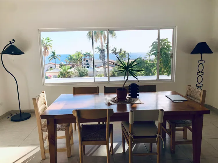 A bright dining area with ocean view and modern decor.