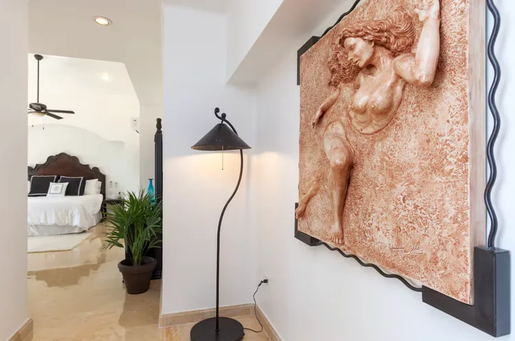 Stylish interior featuring a decorative wall sculpture and plant.