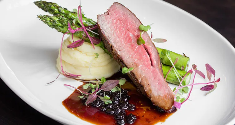 Plate of beef tri-tip with asparagus and mashed potatoes.