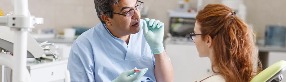 Dentist consulting a patient in a dental clinic.