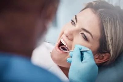A patient smiling during a dental examination.