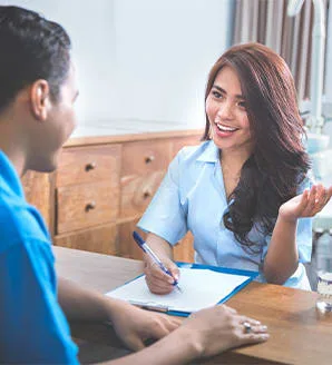 A woman consults a patient in a dental office.