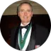 David M. in a tuxedo with a green medal.