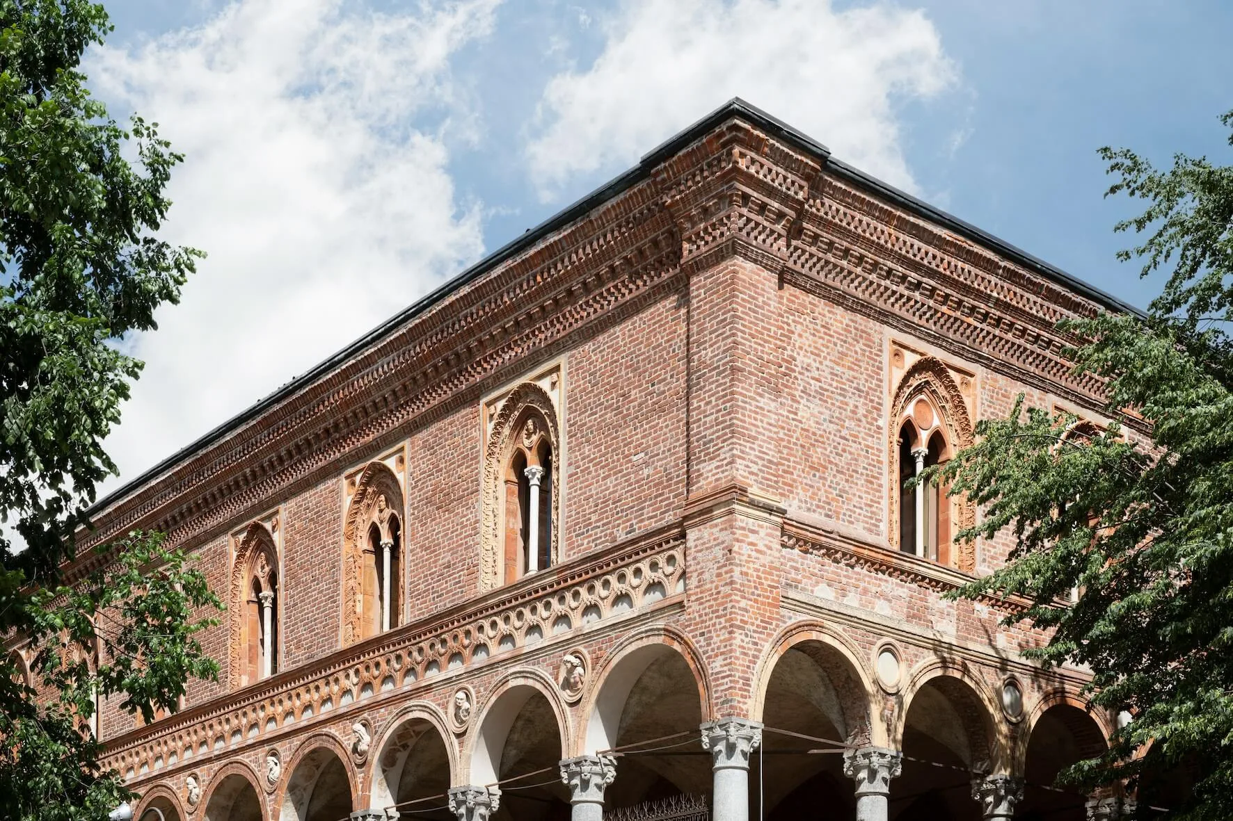 A historic brick building with decorative arches and columns.
