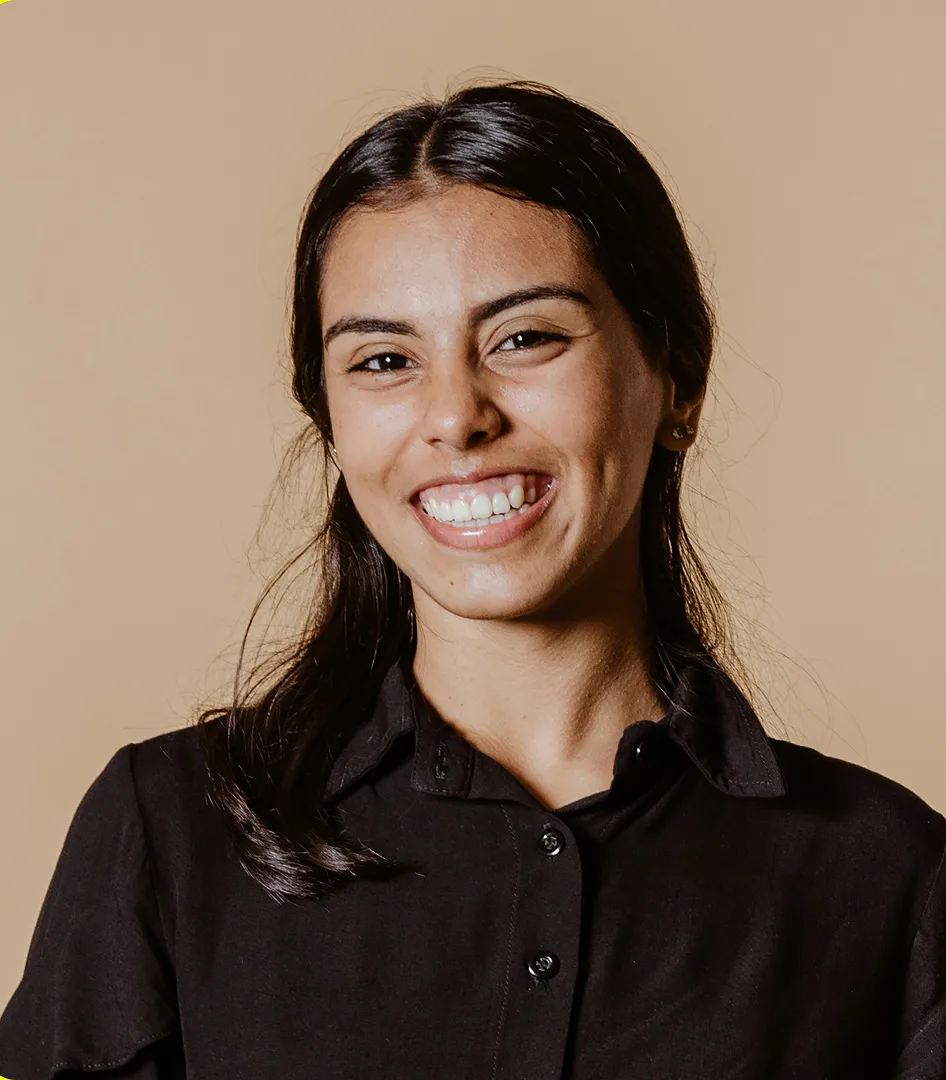 A smiling young woman in a black shirt.