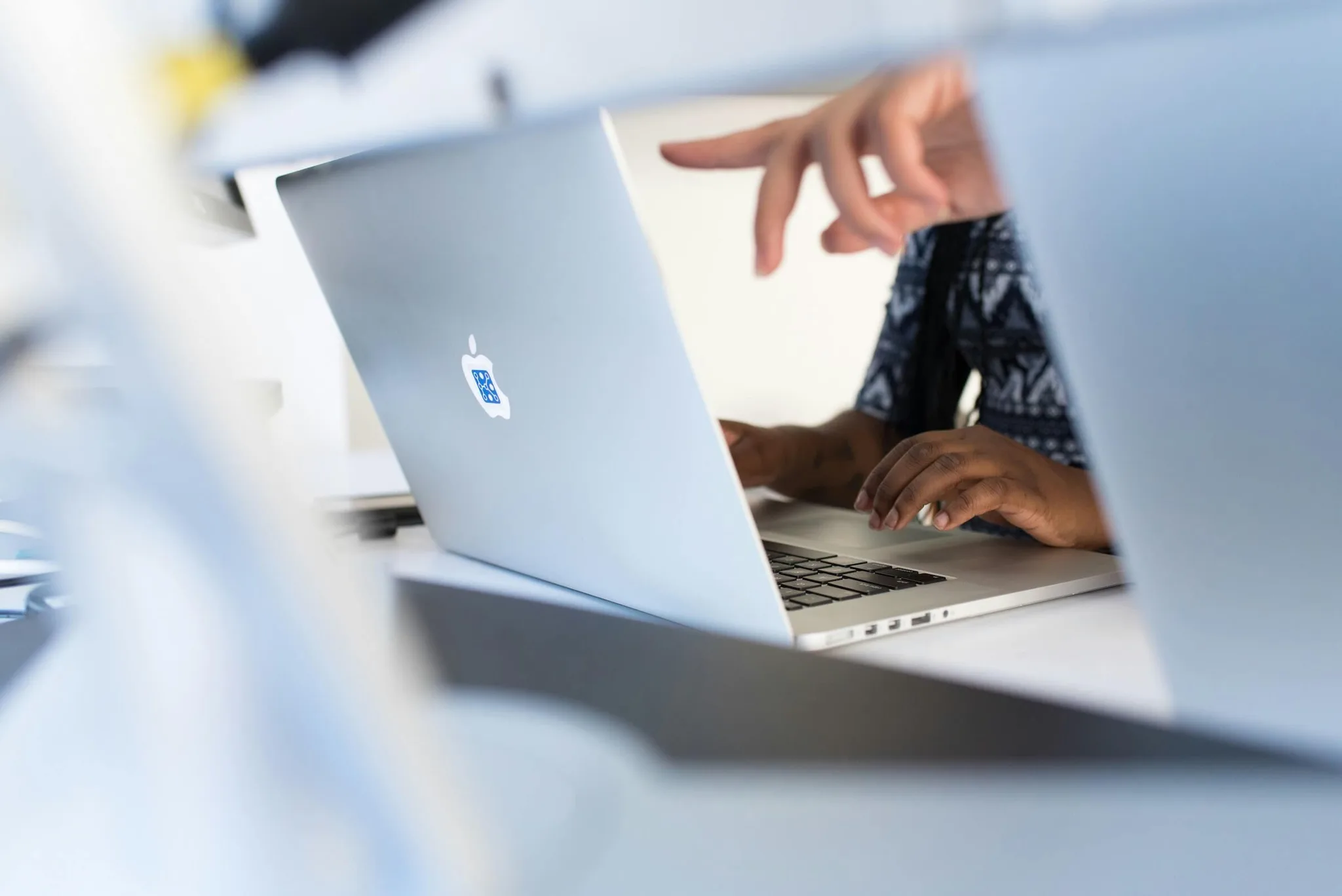 A person working on a laptop in a modern workspace.