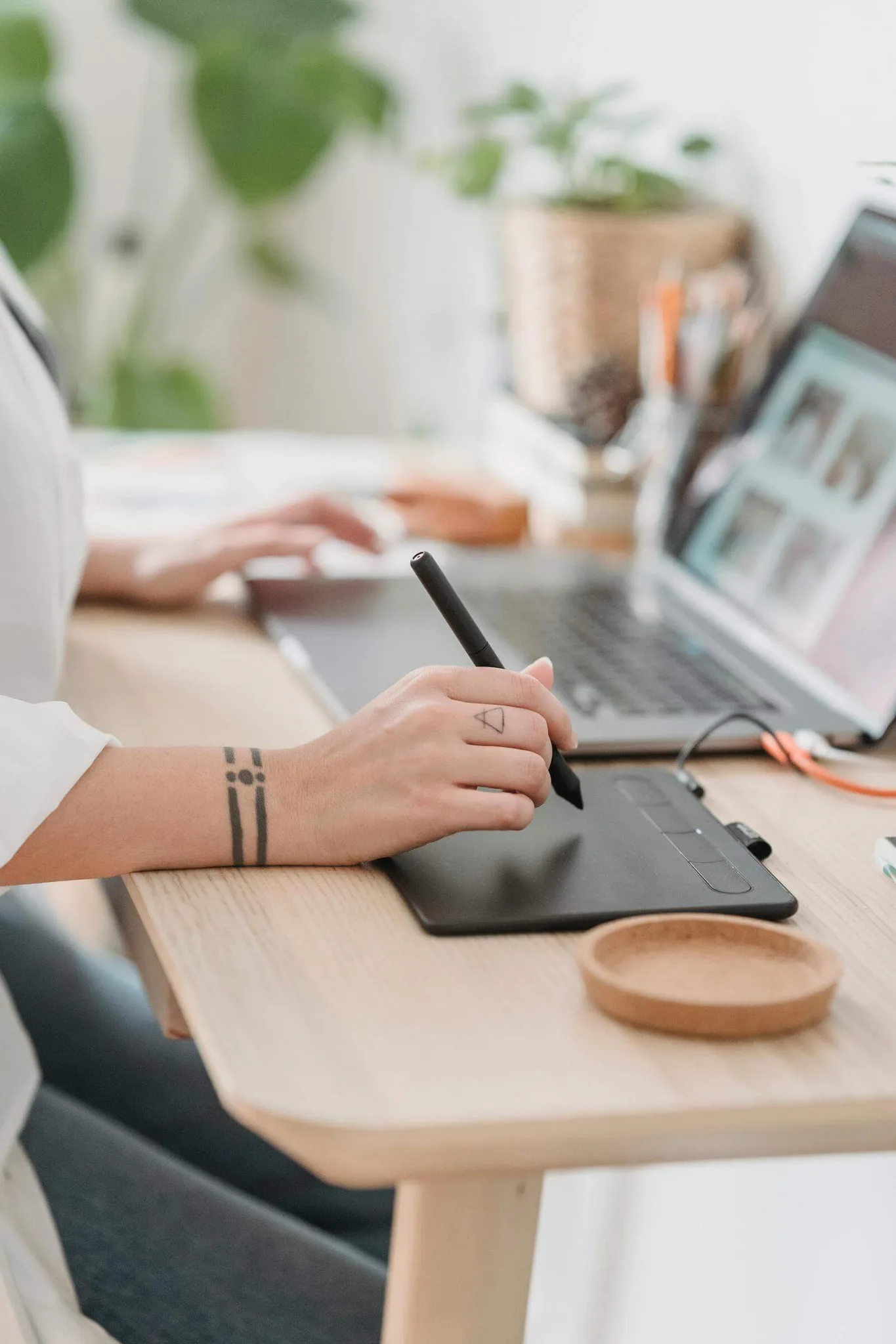 A person using a graphics tablet at a desk