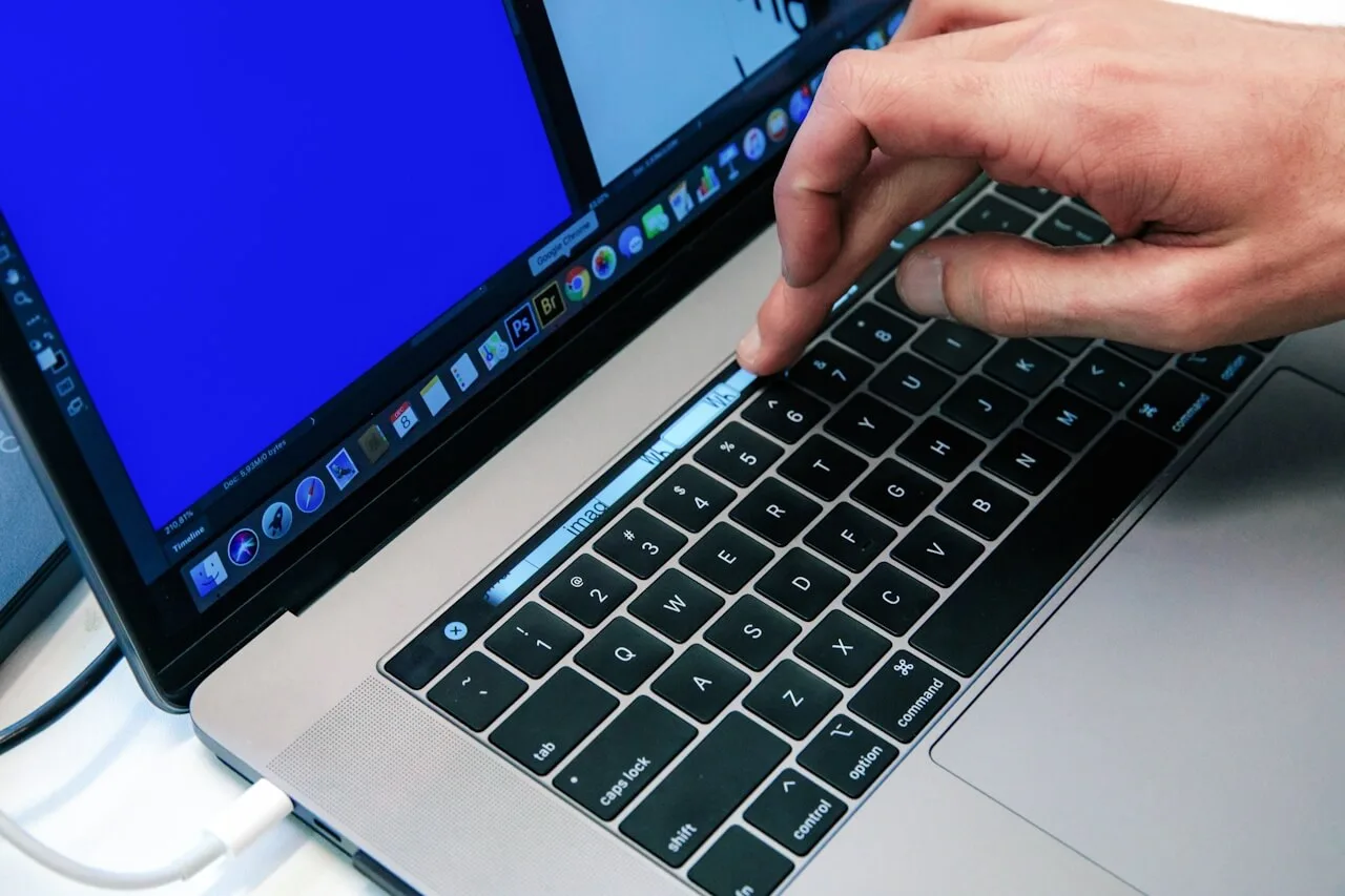 A person using a laptop with a blue screen.