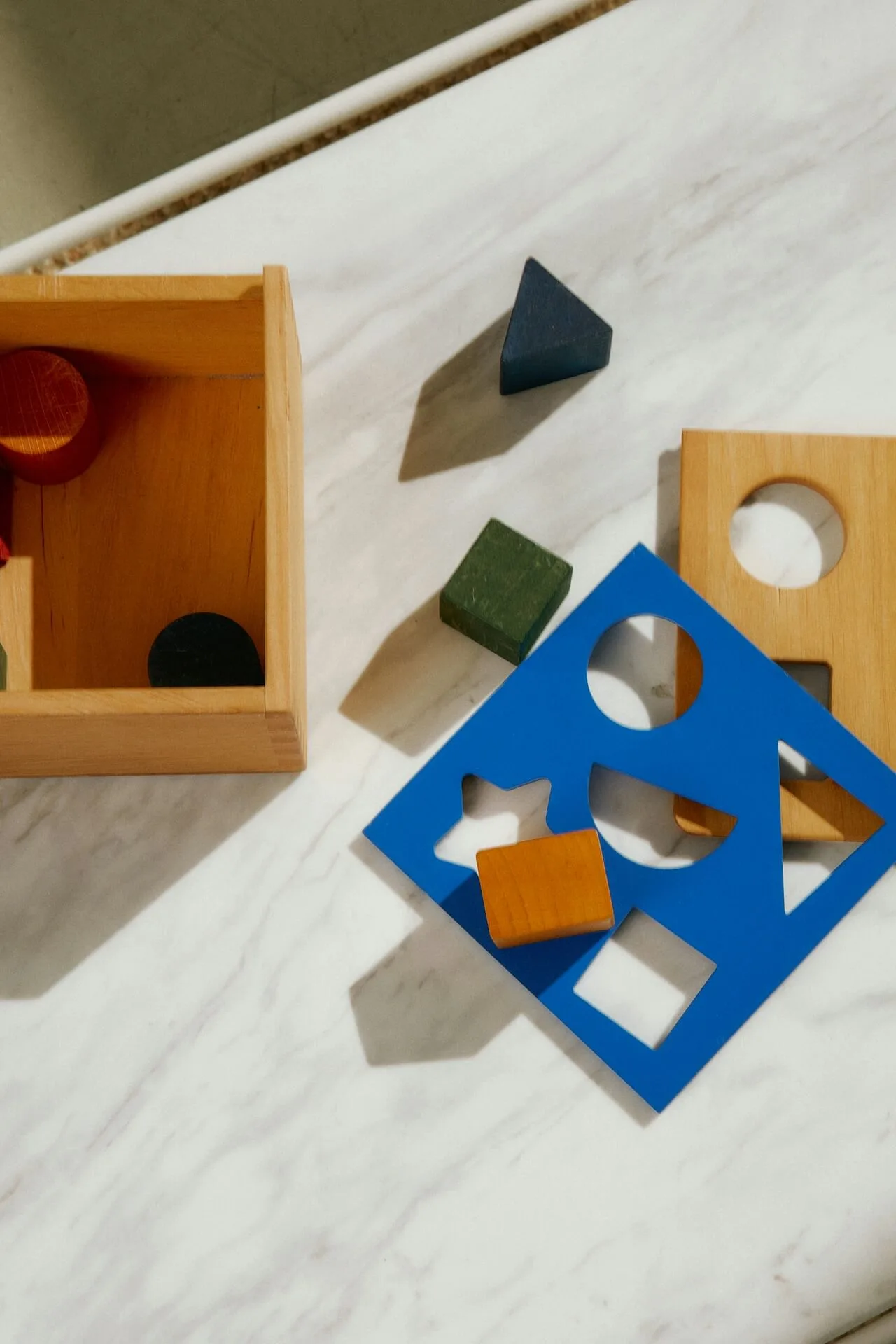Colorful wooden shapes scattered on a surface.