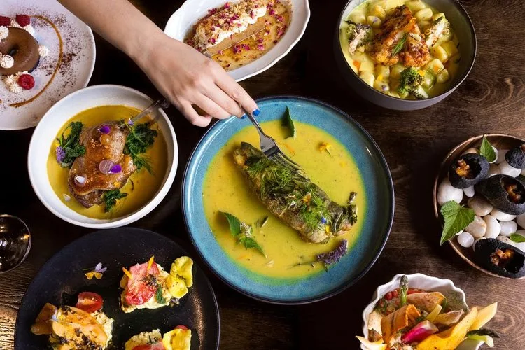 An assortment of Indian dishes on a wooden table.