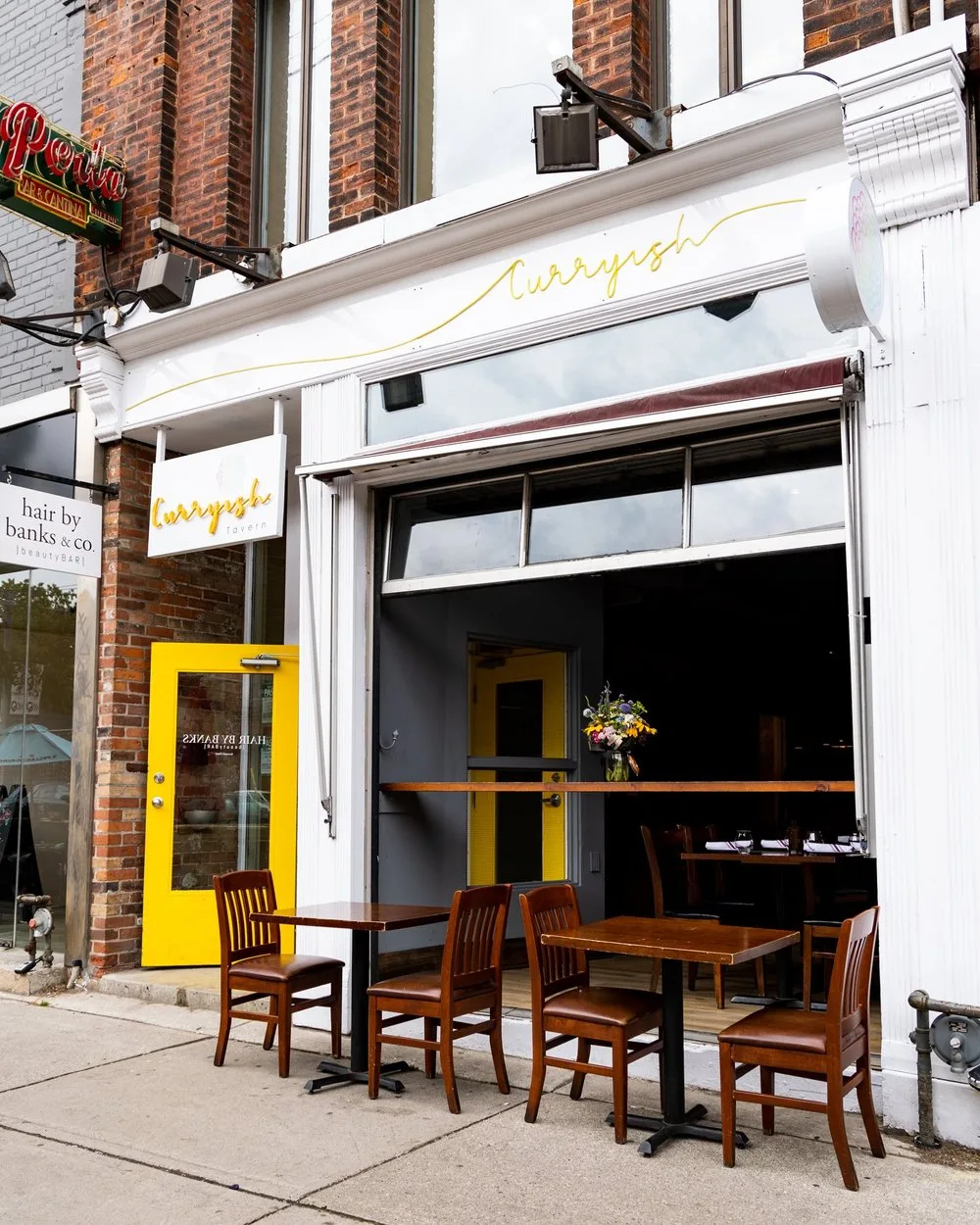 Exterior of Curryish Tavern with outdoor seating