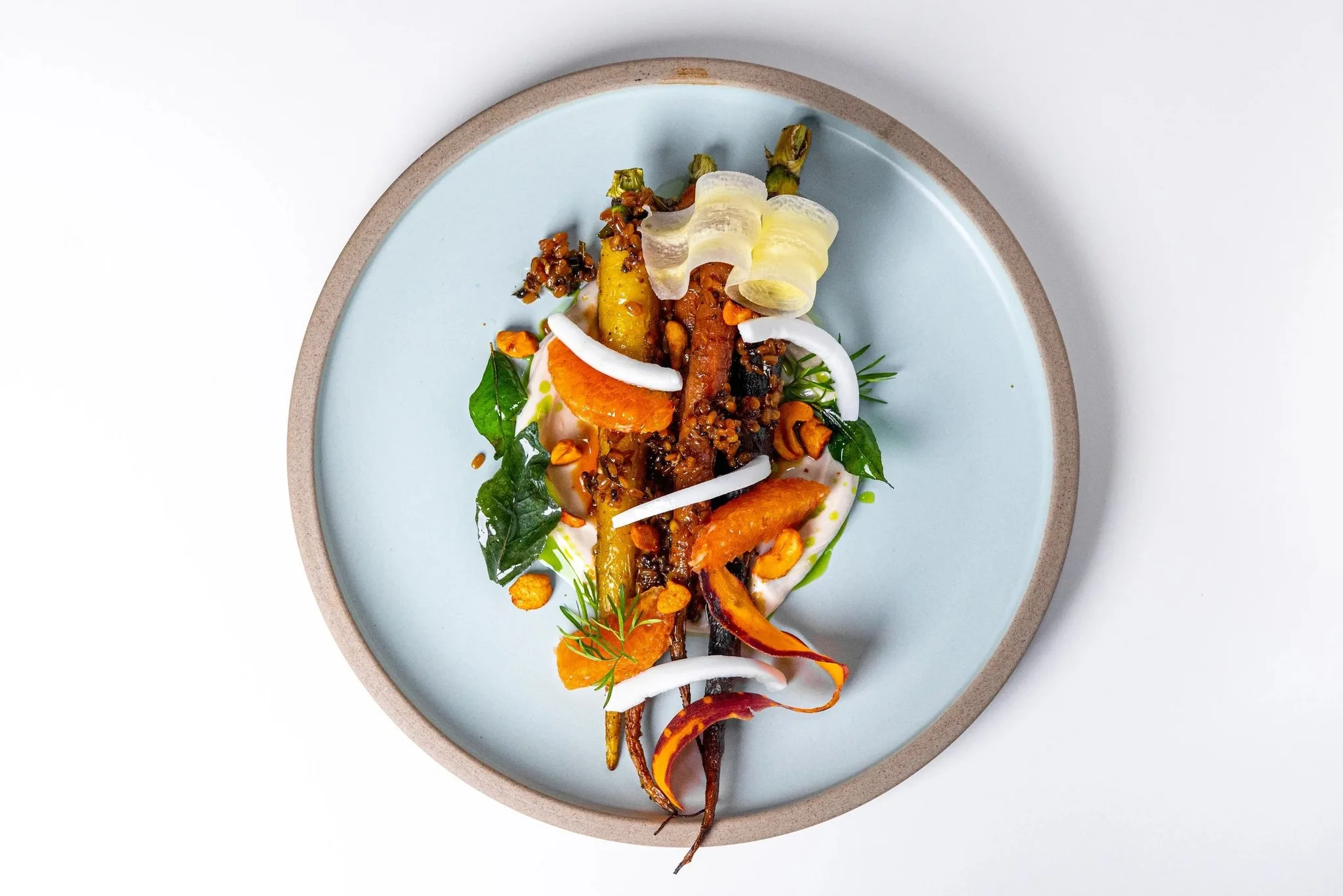A beautifully plated dish of roasted carrots and vegetables.