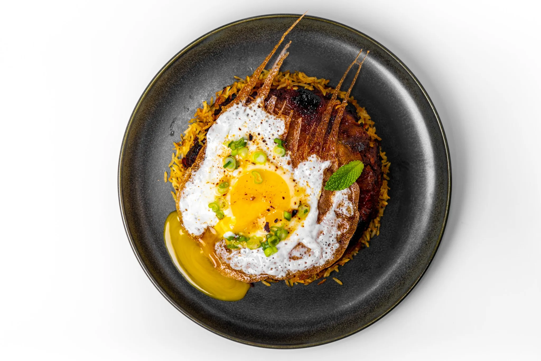 A flavorful biryani dish with egg and herbs.