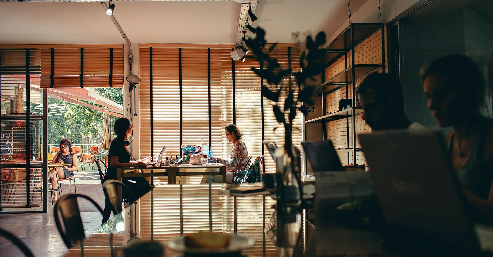 A modern coworking space with people working on laptops.