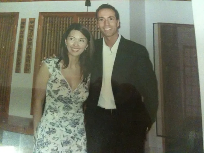 A woman in a floral dress and a man in a suit.
